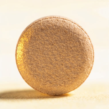 Close-up of a single Tum & Tail chicken-flavour tablet